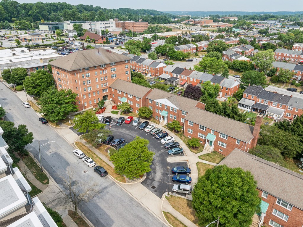 an aerial view of an apartment complex and parking lot