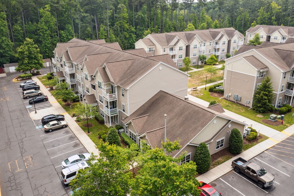 An aerial view of Cambridge Commons with cars parked in the parking lot.