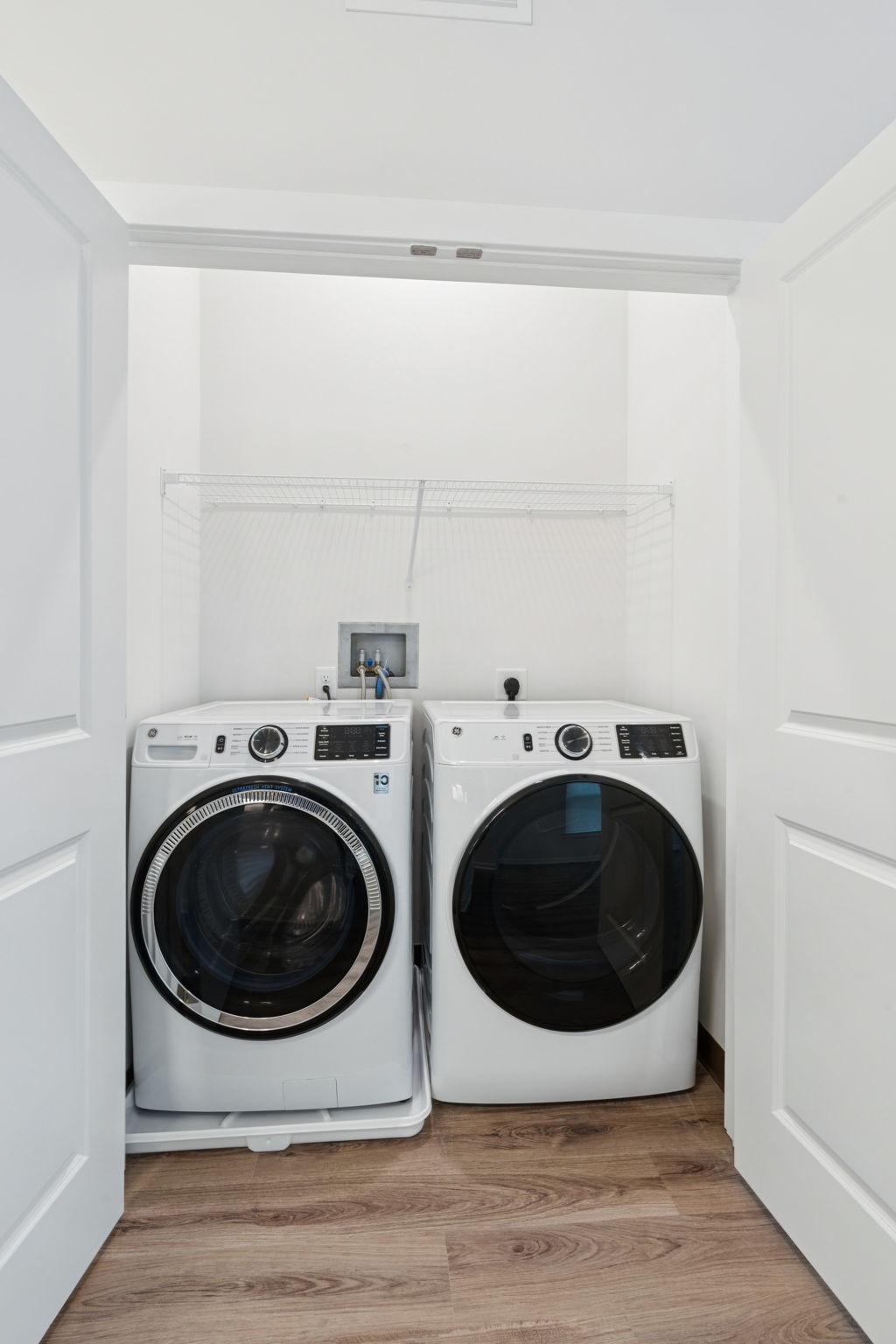 Two front loading washing machines in a laundry room.