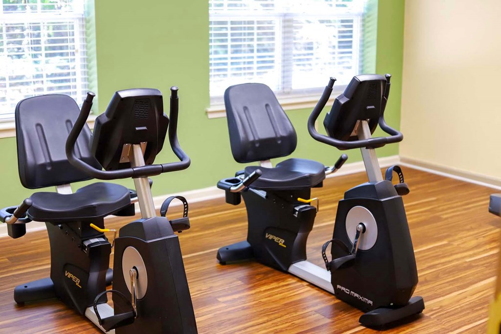 a row of exercise machines in a gym