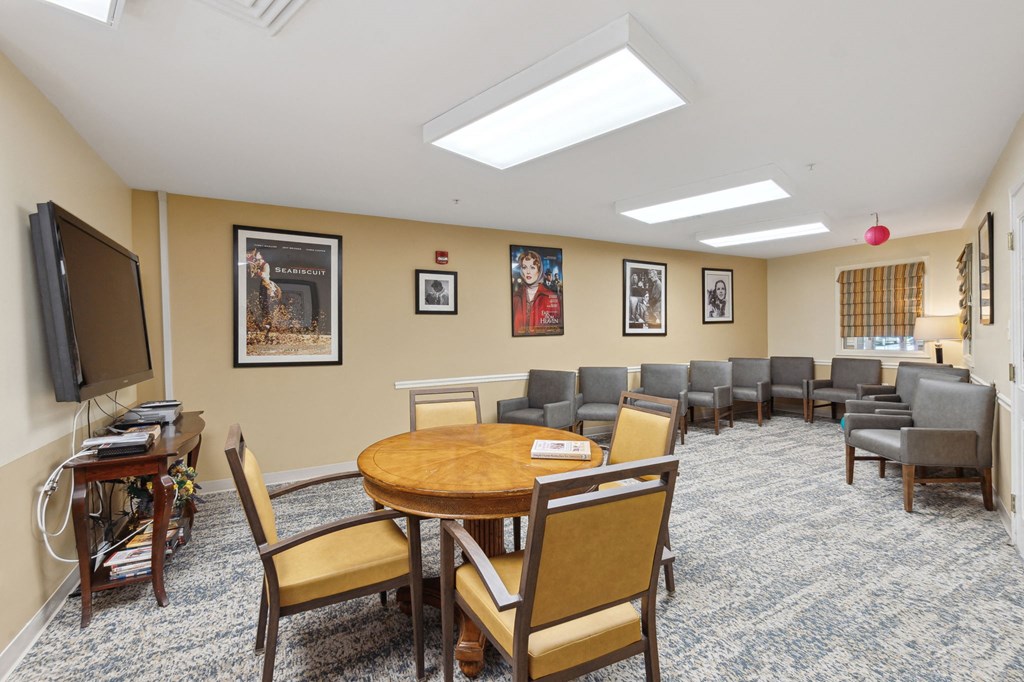 a conference room with a table and chairs and a flat screen tv on the wall