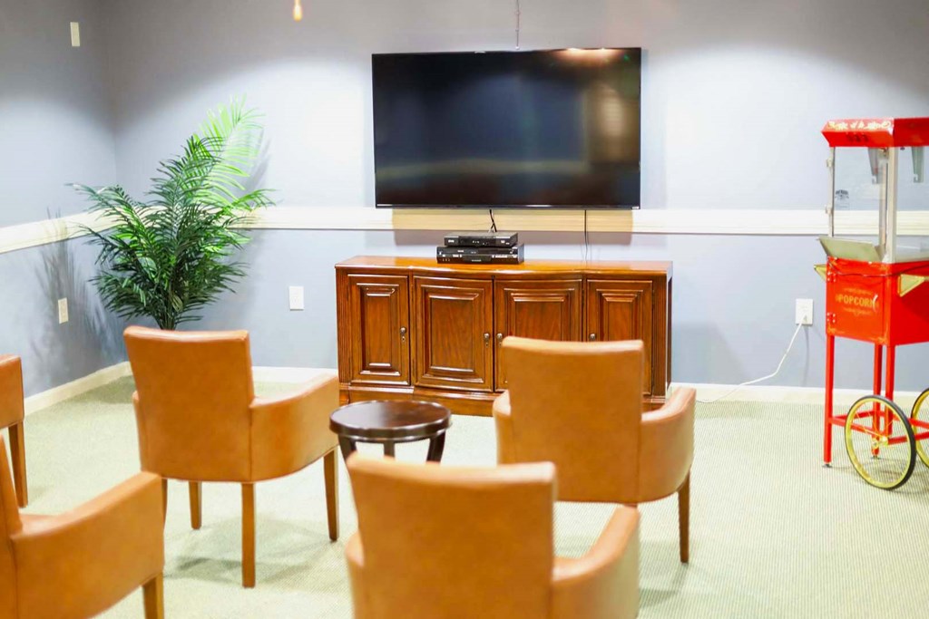 a living room with a table and chairs and a television
