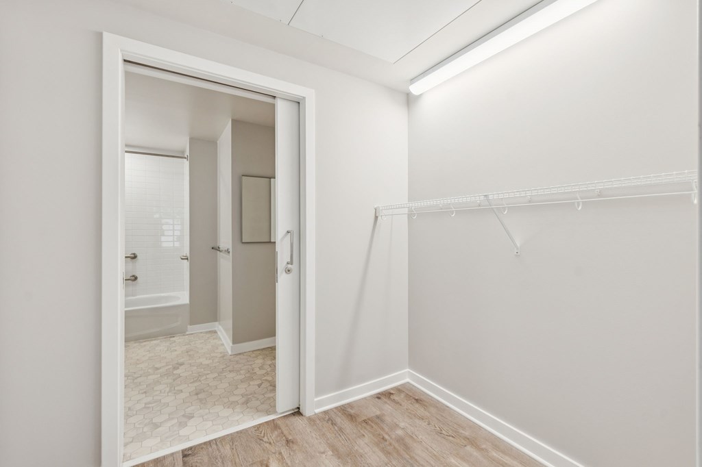 A white room with a doorway leading to another room.