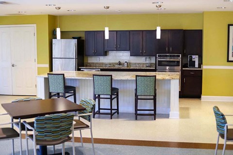 an open kitchen and dining area with a table and chairs