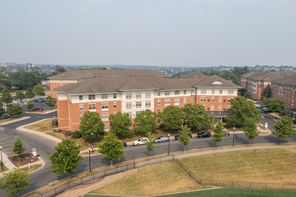 a large brick building with trees in front of it
