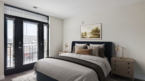A bedroom with a large bed, a nightstand, and a painting on the wall.