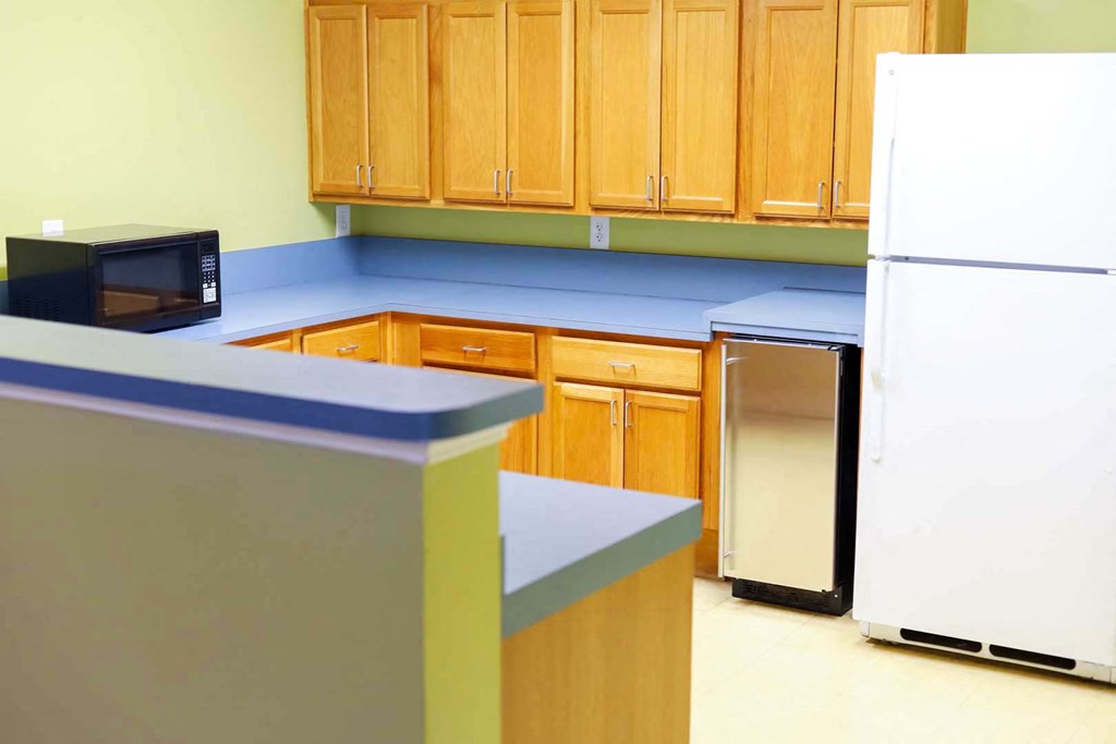 a kitchen with a refrigerator and a microwave