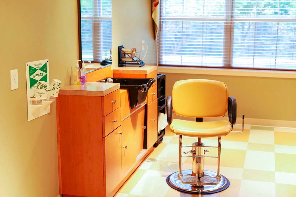 a chair in a room with a desk and a window
