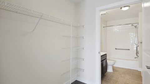A white bathroom with a walk-in shower and toilet.