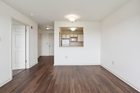 A room with wooden floors and white walls.