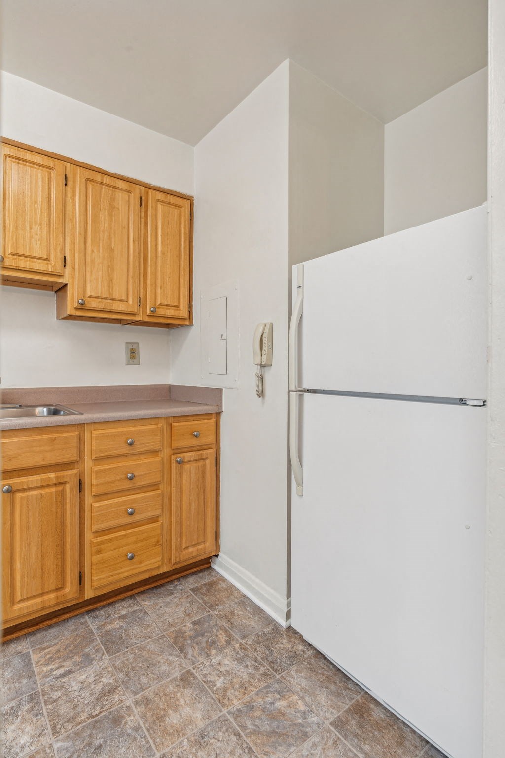 Kitchen with refrigerator, stove, and cabinetry in Towson senior housing