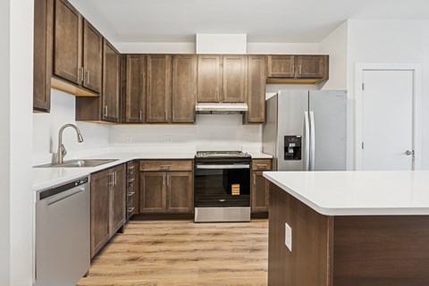 A kitchen with wooden cabinets and a white countertop.
