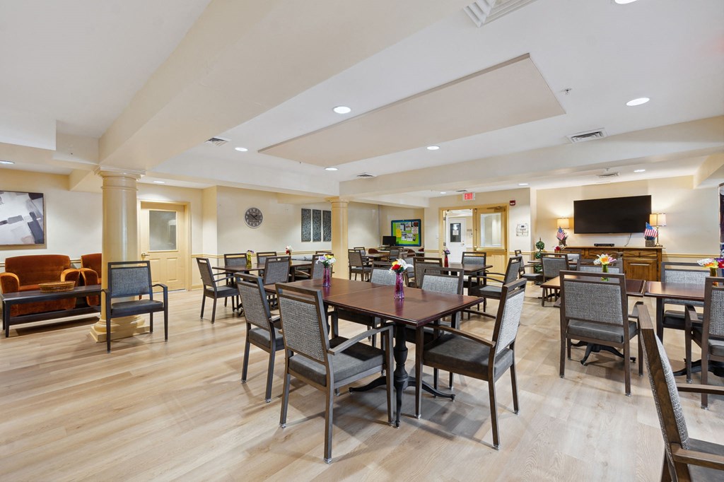 a large room with a large table and chairs and a flat screen tv on the wall
