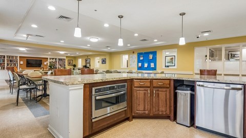 A kitchen with a white island and wooden cabinets.