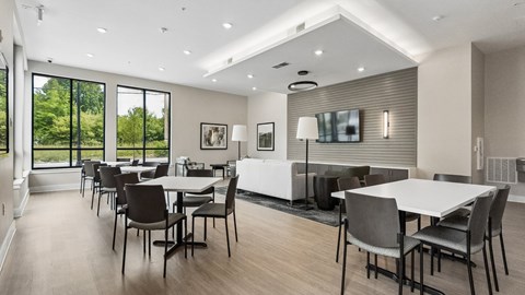 A modern dining room with a large table and chairs.