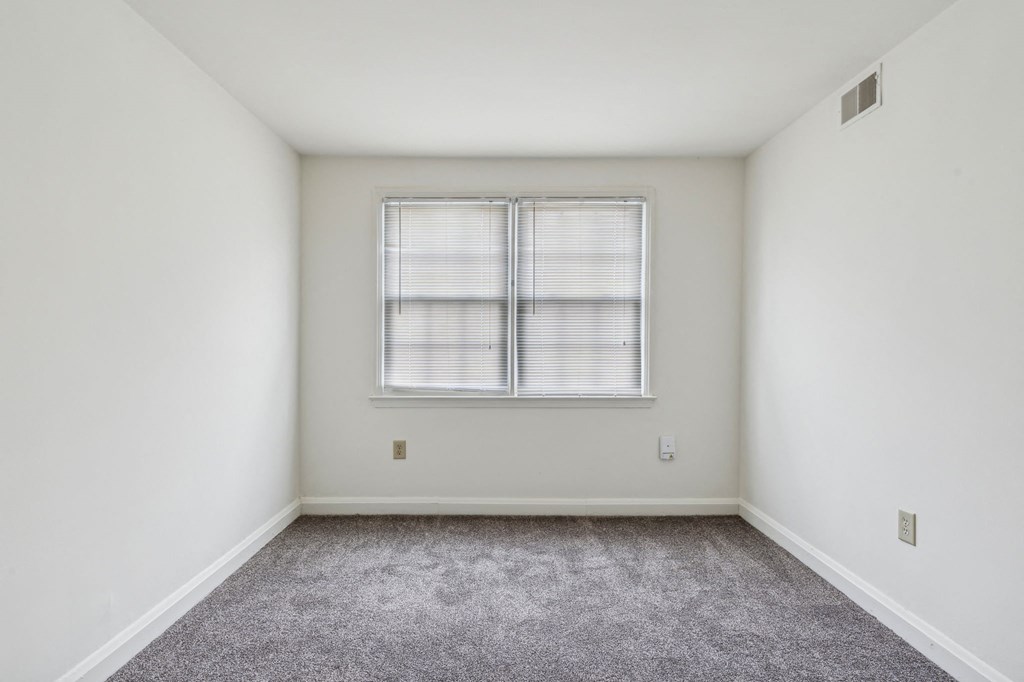 Carpeted bedroom in Park View at Towson with two windows and closet space