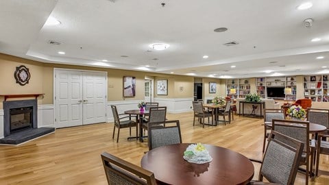 A dining room with a fireplace and a table set for a meal.