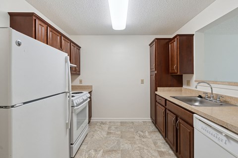 a kitchen with white appliances and brown cabinets