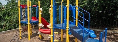 an empty playground with slides and other toys