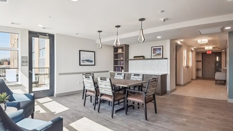 A dining room with a table set for six.