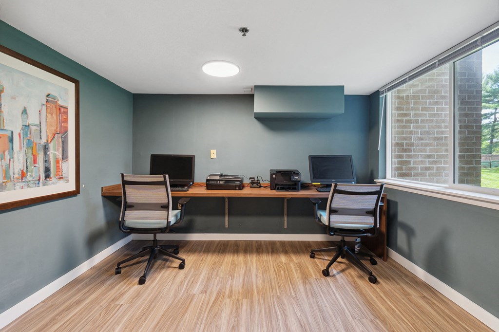 a room with two computers and two chairs
