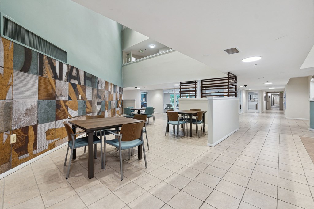 a seating area with tables and chairs