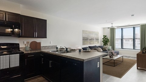 A modern kitchen with dark brown cabinets and a large island.