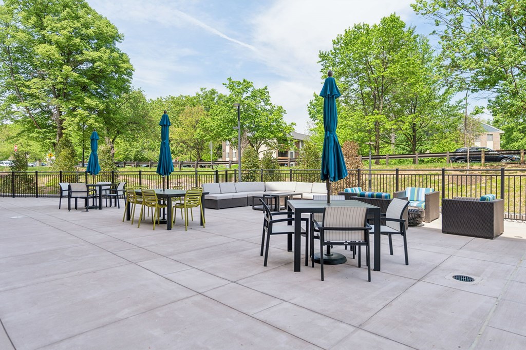Legacy at Twin Rivers patio with tables and chairs and umbrellas