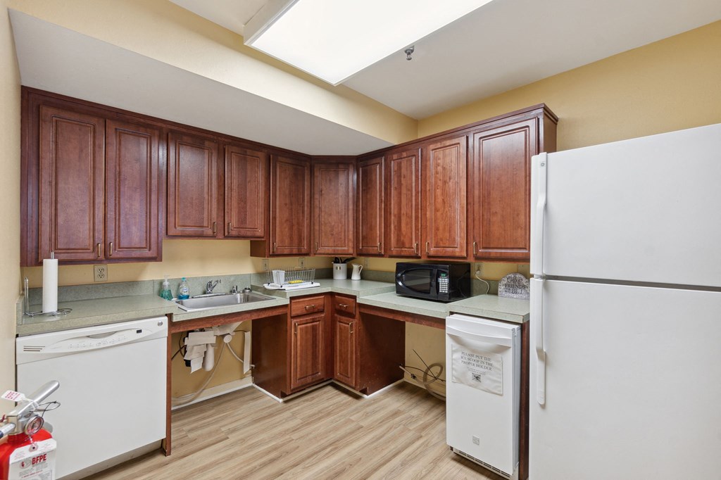 a kitchen with white appliances and wooden cabinets