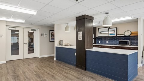 A kitchen with a blue counter and a brown cabinet.
