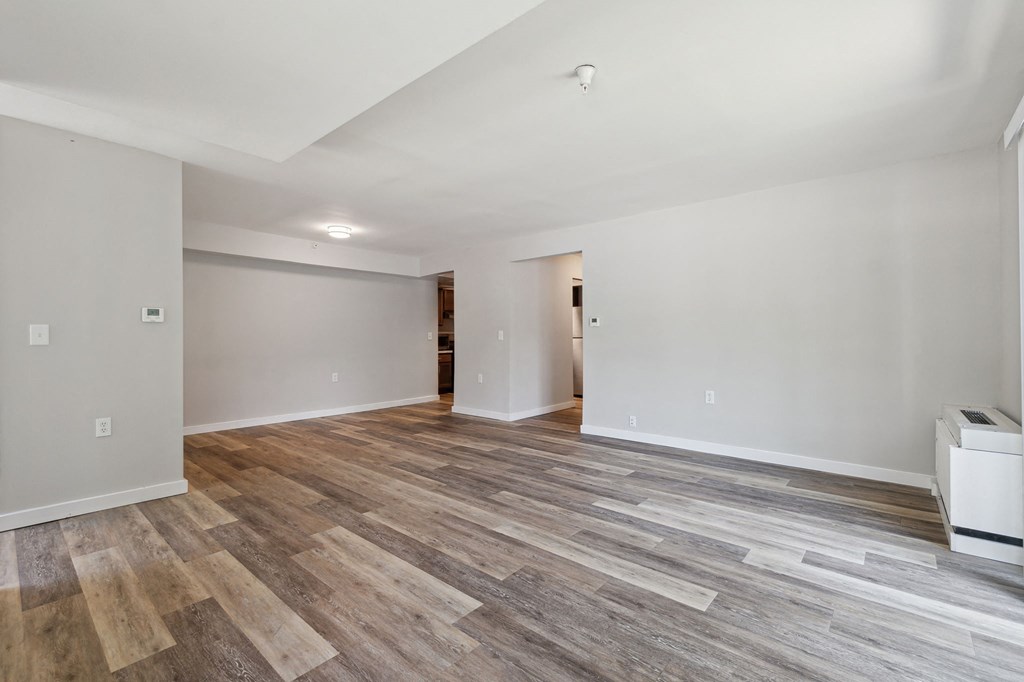 a living room with hardwood floors and grey walls