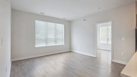 A spacious room with a window and a door.