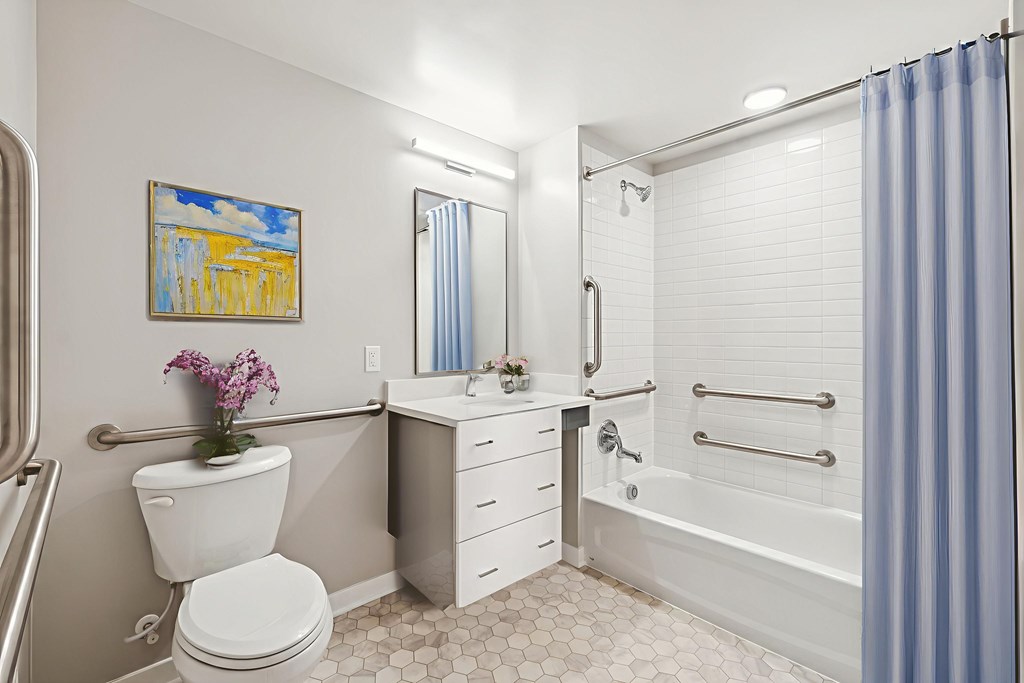 A bathroom with a toilet, sink, and bathtub.