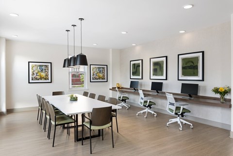 A conference room with a long table and chairs.