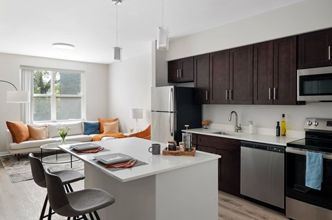 A modern kitchen with a dining table and chairs.
