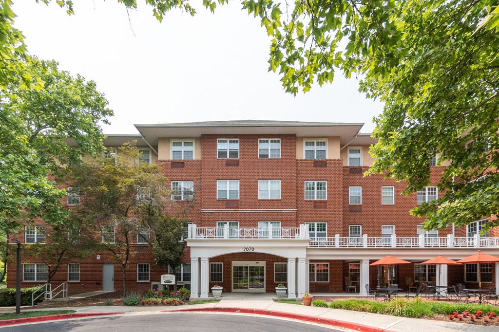a large brick building with trees in front of it