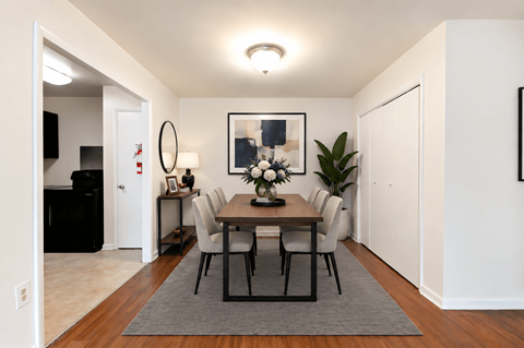 A dining room with a table set for six.