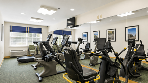 A gym with treadmills, exercise bikes, and elliptical machines.