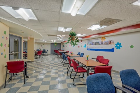 a dining room with tables and chairs and a checkered floor