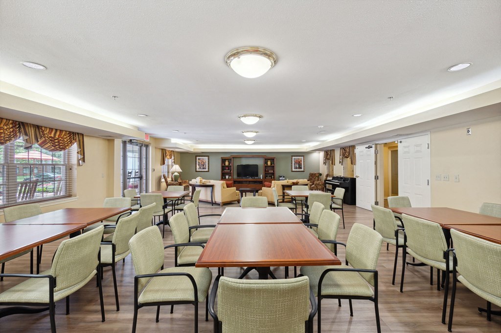a large room with tables and chairs and a fireplace