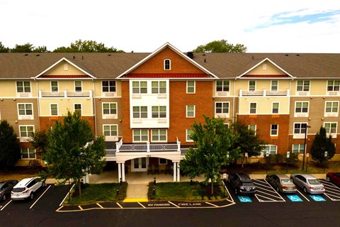 an aerial view of an apartment building with a parking lot