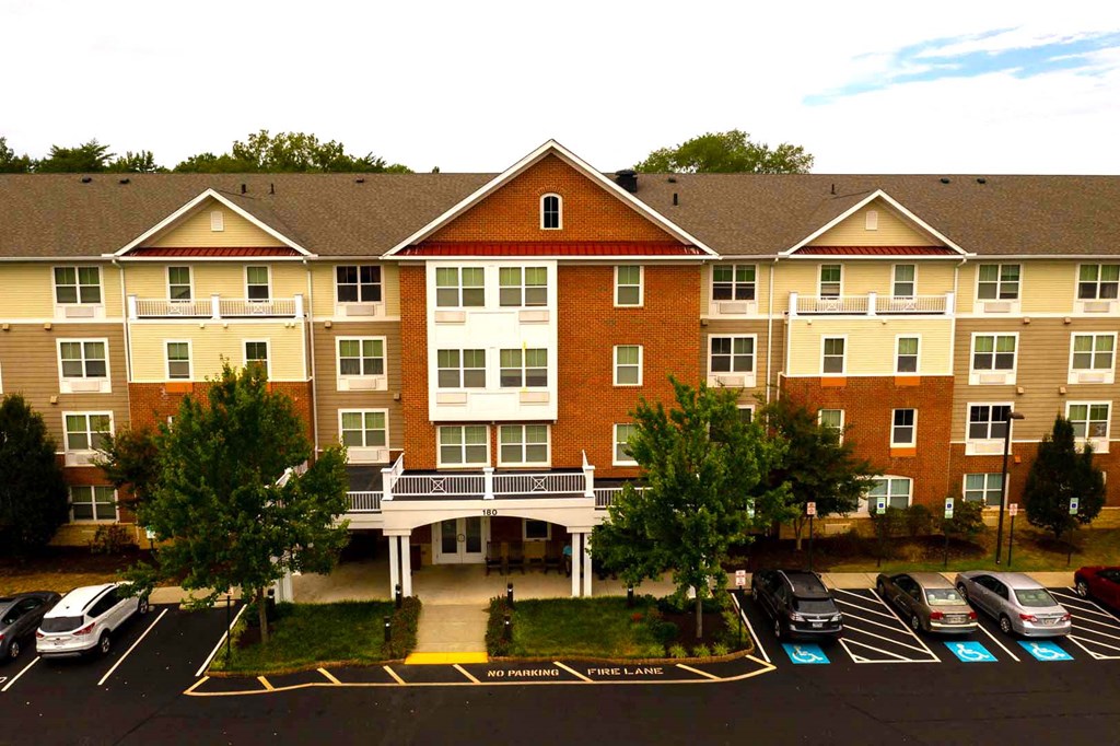 an aerial view of an apartment building with a parking lot