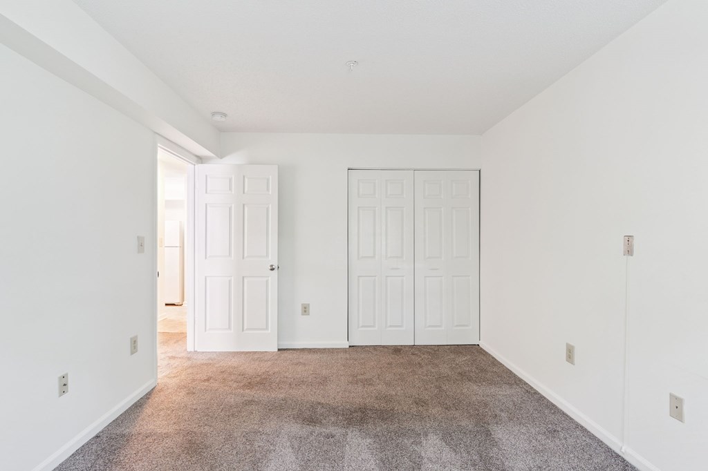 A room with white walls and a carpeted floor.