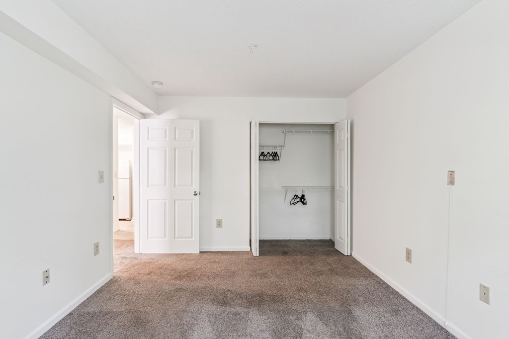 A room with white walls and a carpeted floor.
