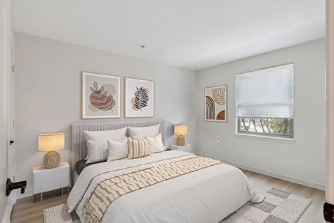 A bedroom with a large bed and a window.