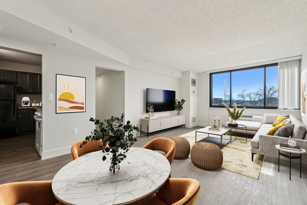 Spacious living room inside a market-rate 2-bedroom apartment at Edgewood Commons 611 & Gardens in Northeast D.C., featuring luxury vinyl flooring, abundant natural light, and an open layout—perfect for relaxing or entertaining.