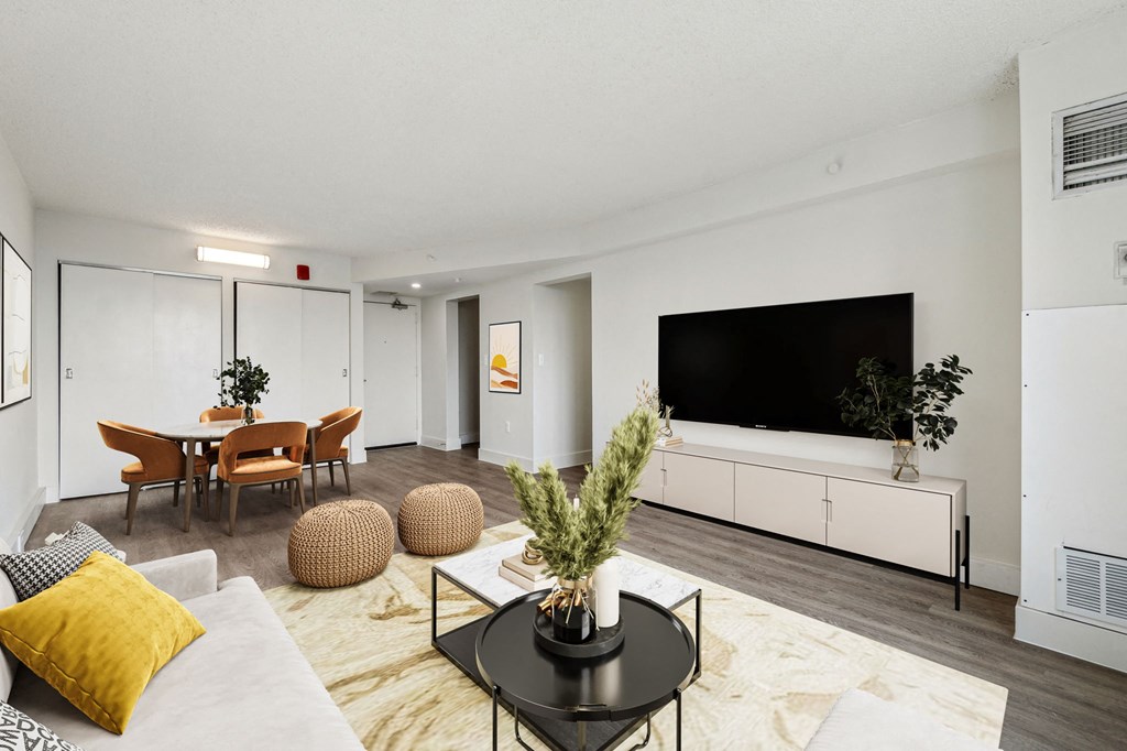 Spacious living room inside a market-rate 2-bedroom apartment at Edgewood Commons 611 & Gardens in Northeast D.C., featuring luxury vinyl flooring, abundant natural light, and an open layout—perfect for relaxing or entertaining.
