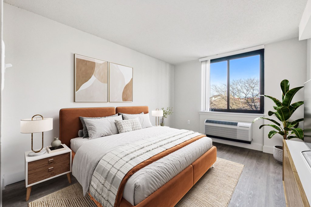 Bright, airy bedroom in a market-rate 2-bedroom apartment at Edgewood Commons 611 & Gardens, with generous closet space, luxury vinyl flooring, and plenty of natural light—ideal for comfort and rest.