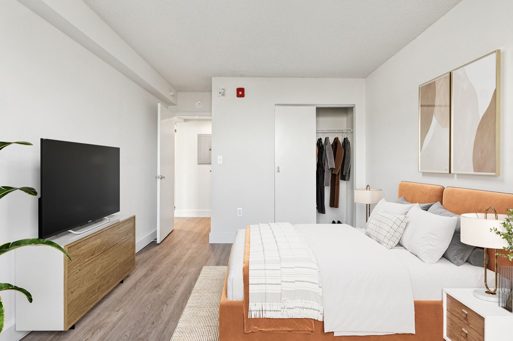 Bright, airy bedroom in a market-rate 2-bedroom apartment at Edgewood Commons 611 & Gardens, with generous closet space, luxury vinyl flooring, and plenty of natural light—ideal for comfort and rest.
