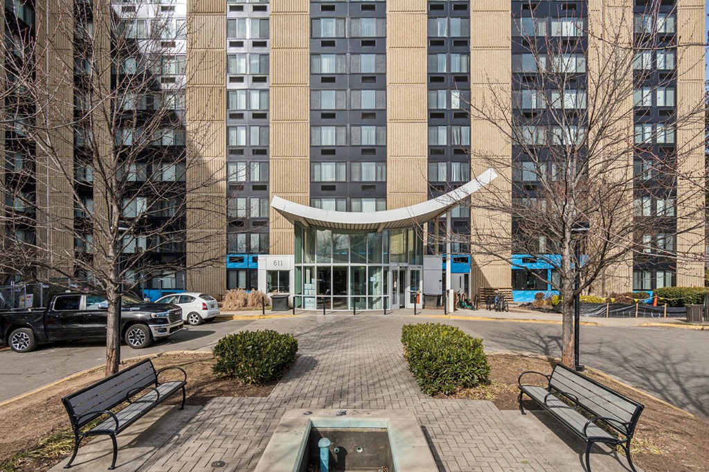 Exterior view of Edgewood Commons 611 & Gardens, a modern high-rise and garden-style apartment community in Northeast Washington, D.C., offering market-rate 1- and 2-bedroom homes. The building features landscaped grounds, convenient access to public transportation, and a welcoming atmosphere near Rhode Island and Brookland Metro stations.